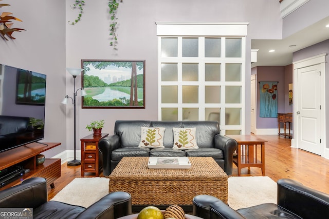 living room featuring baseboards, recessed lighting, and wood finished floors
