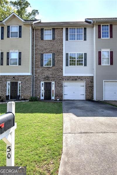 50 Westside Chase, Cartersville, GA 30120 - view of property featuring an attached garage, driveway, and a front lawn