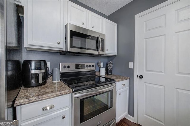 50 Westside Chase, Cartersville, GA 30120 - kitchen featuring white cabinets, stainless steel appliances, stone counters, and a textured ceiling