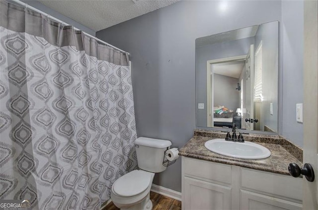 50 Westside Chase, Cartersville, GA 30120 - bathroom featuring wood finished floors, toilet, vanity, a textured ceiling, and ensuite bathroom