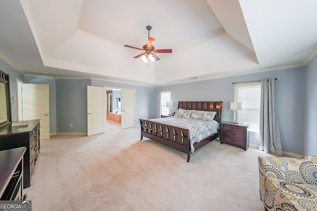 bedroom featuring light carpet, ornamental molding, and a tray ceiling