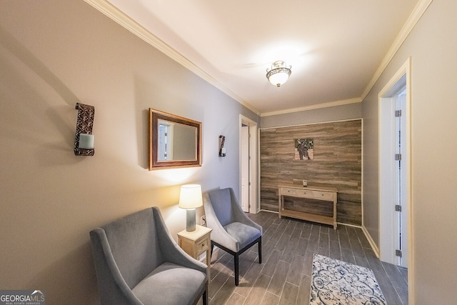living area with baseboards, wood finished floors, and ornamental molding