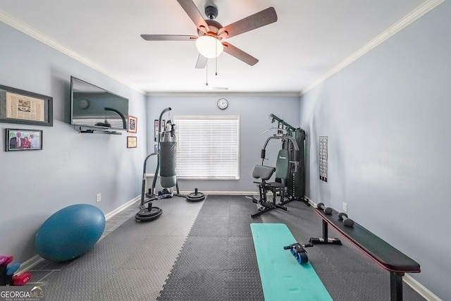 exercise area featuring a ceiling fan, baseboards, and ornamental molding