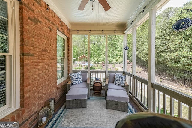 sunroom with a ceiling fan