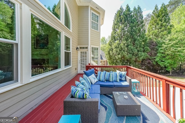 wooden terrace with an outdoor living space