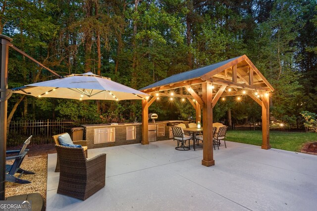view of patio / terrace featuring outdoor dining area, a gazebo, fence, and area for grilling