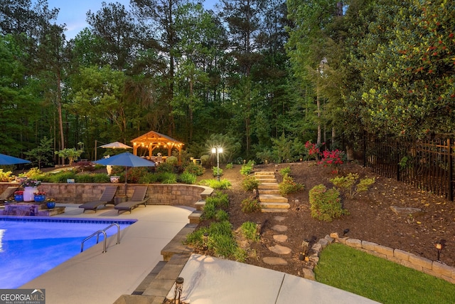 view of swimming pool with fence, a fenced in pool, stairway, and a patio