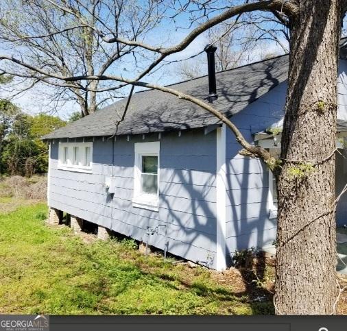 1323 S Hairston Rd, Stone Mountain, GA 30088 - view of side of home with a shingled roof