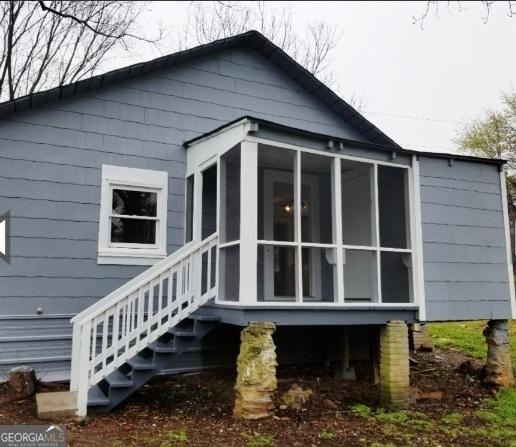 1323 S Hairston Rd, Stone Mountain, GA 30088 - rear view of property featuring a sunroom