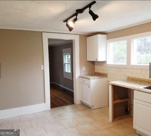 1323 S Hairston Rd, Stone Mountain, GA 30088 - kitchen with white cabinetry, a healthy amount of sunlight, and light countertops