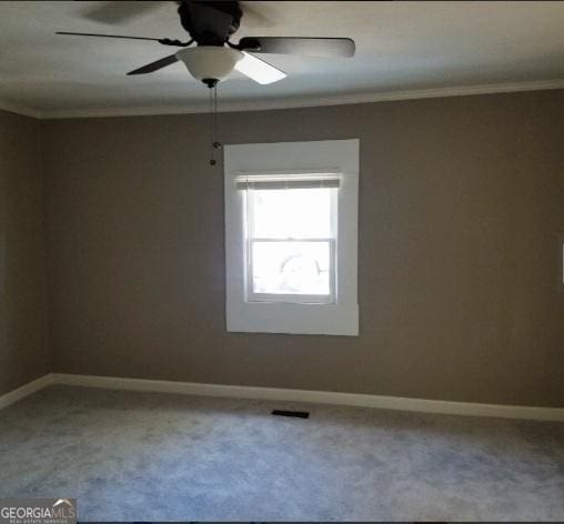 1323 S Hairston Rd, Stone Mountain, GA 30088 - spare room featuring a ceiling fan, carpet flooring, baseboards, and ornamental molding