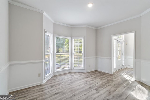 unfurnished room with wood finished floors and crown molding