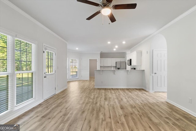 unfurnished living room with crown molding, recessed lighting, light wood finished floors, baseboards, and a ceiling fan