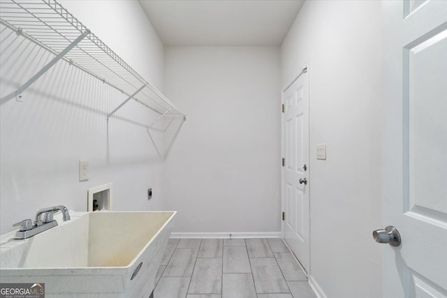 clothes washing area with washer hookup, electric dryer hookup, and baseboards