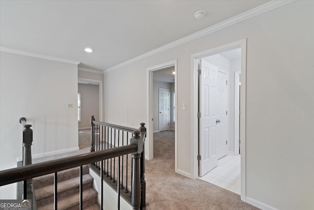 corridor with an upstairs landing, light colored carpet, baseboards, crown molding, and recessed lighting