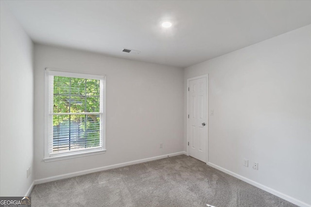 carpeted empty room with baseboards