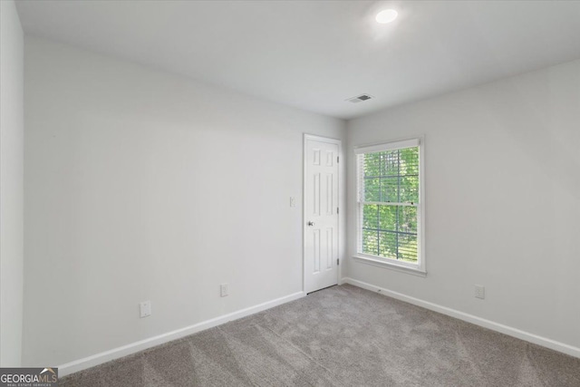 carpeted empty room with baseboards and recessed lighting