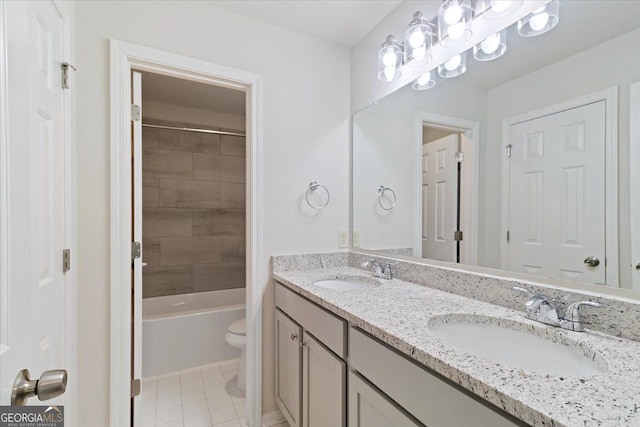 full bathroom with toilet, double vanity, and tile patterned flooring