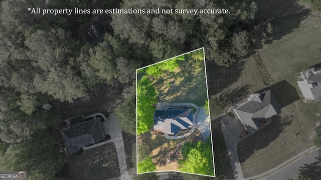 aerial view of property and surrounding area featuring property parcel outlined