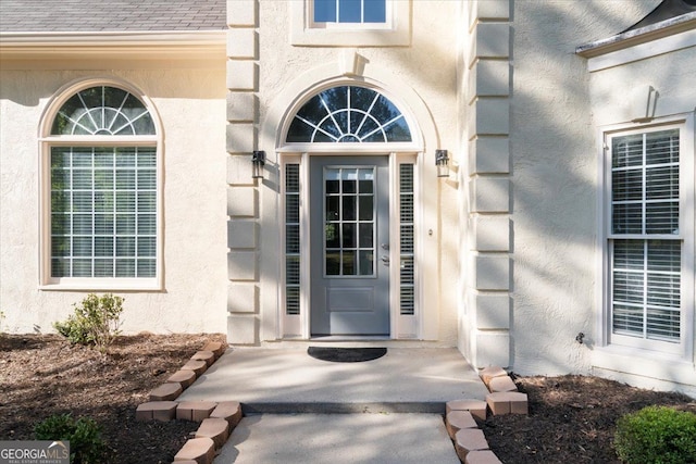 doorway to property with stucco siding
