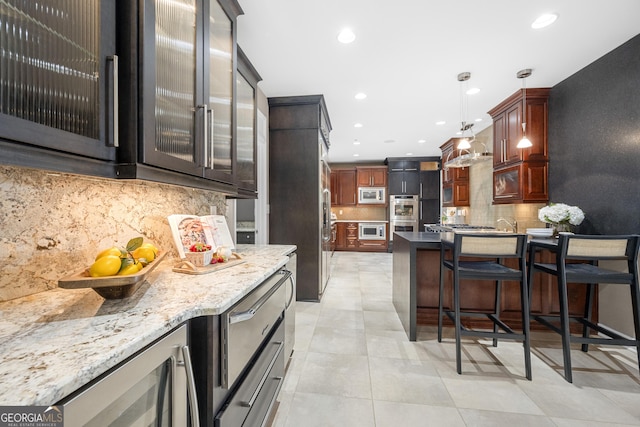 kitchen featuring recessed lighting, wine cooler, backsplash, a kitchen bar, and appliances with stainless steel finishes