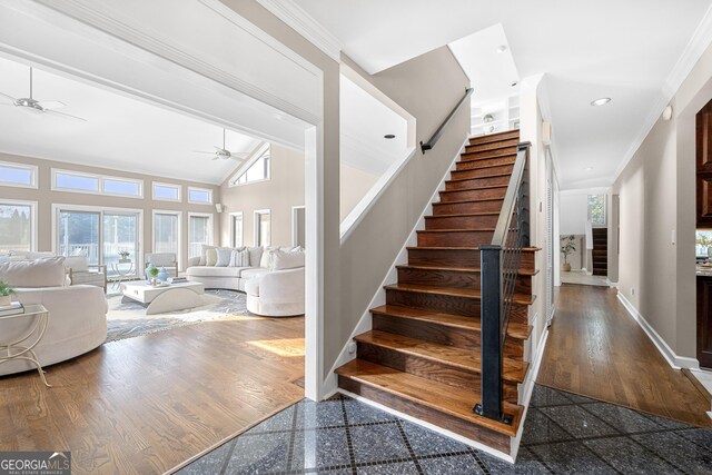 staircase with ceiling fan, baseboards, ornamental molding, and granite finish floor