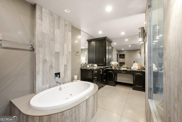 full bath with tile patterned floors, recessed lighting, walk in shower, a tub with jets, and vanity