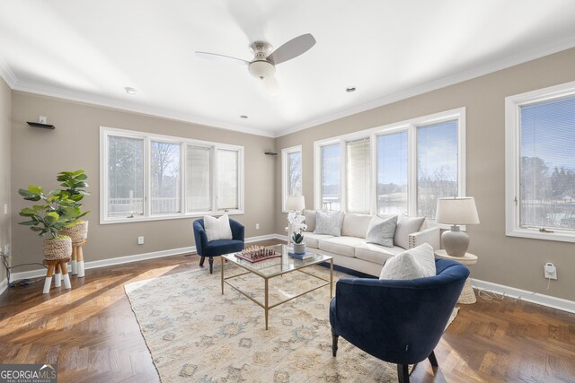 living room with crown molding, baseboards, and a healthy amount of sunlight