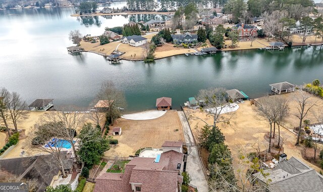 birds eye view of property with a water view and a residential view