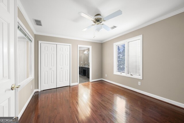 unfurnished bedroom featuring a closet, visible vents, baseboards, and dark wood-style flooring