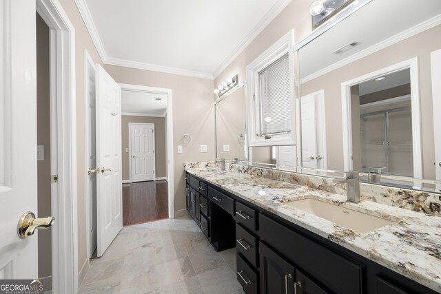 full bathroom with crown molding, a sink, double vanity, baseboards, and visible vents