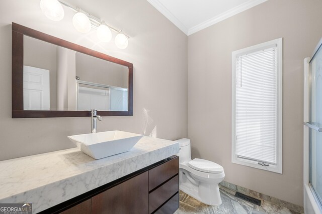 bathroom with an enclosed shower, vanity, toilet, ornamental molding, and visible vents