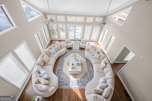living room featuring a ceiling fan, wood finished floors, and ornamental molding