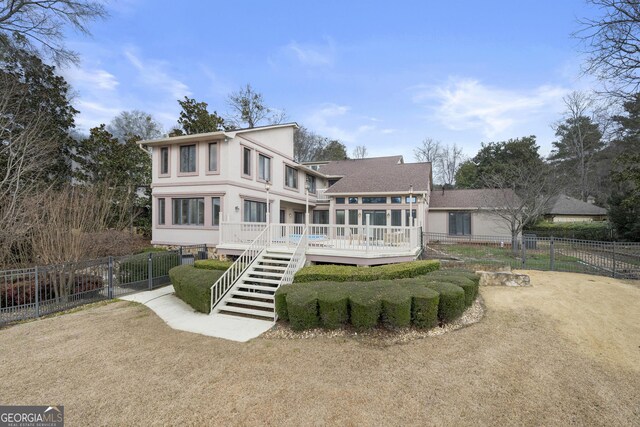 rear view of property with fence, a wooden deck, roof with shingles, and stairway