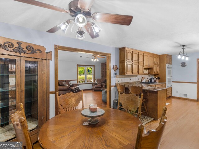 930 Singley Dr, Locust Grove, GA 30248 - dining area featuring light wood finished floors, a ceiling fan, and visible vents