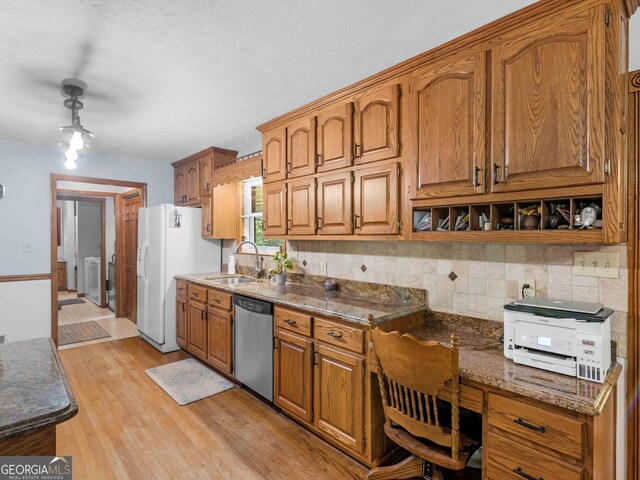 930 Singley Dr, Locust Grove, GA 30248 - kitchen featuring dishwasher, backsplash, brown cabinets, and a sink