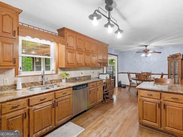 930 Singley Dr, Locust Grove, GA 30248 - kitchen featuring stainless steel dishwasher, tasteful backsplash, a sink, ceiling fan, and light wood-style flooring