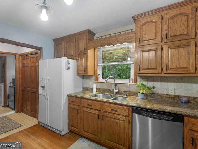 930 Singley Dr, Locust Grove, GA 30248 - kitchen featuring decorative backsplash, stainless steel dishwasher, a sink, and white refrigerator with ice dispenser