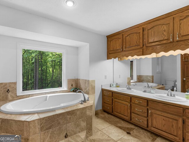 930 Singley Dr, Locust Grove, GA 30248 - full bathroom featuring a bath, toilet, a sink, and double vanity