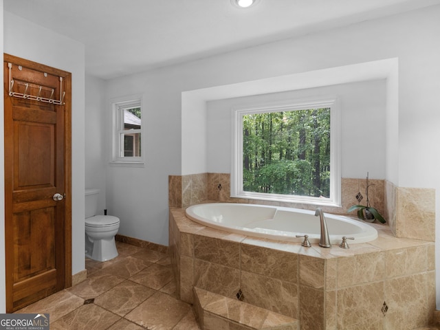 930 Singley Dr, Locust Grove, GA 30248 - bathroom with a garden tub, toilet, and baseboards