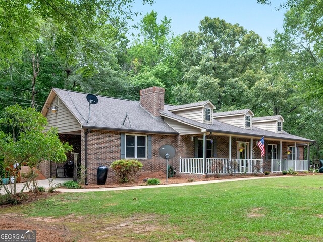 930 Singley Dr, Locust Grove, GA 30248 - view of front of house featuring a chimney, roof with shingles, covered porch, brick siding, and a front yard
