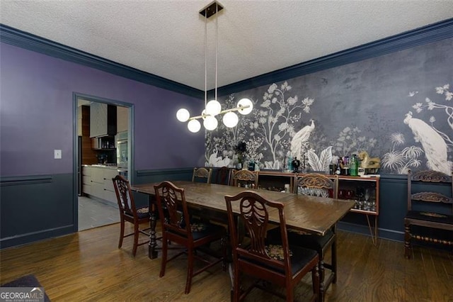 225 Nacoochee Dr, Woodstock, GA 30188 - dining area featuring a textured ceiling, wallpapered walls, ornamental molding, wood finished floors, and a notable chandelier