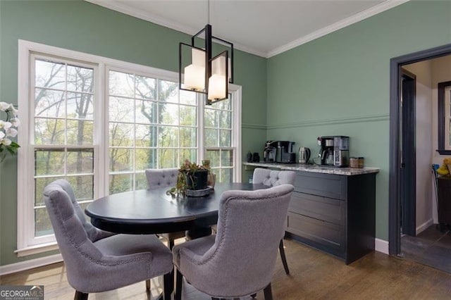 225 Nacoochee Dr, Woodstock, GA 30188 - dining area with crown molding, dark wood-style flooring, and baseboards