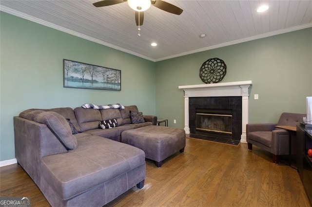 225 Nacoochee Dr, Woodstock, GA 30188 - living room with a tiled fireplace, recessed lighting, wood finished floors, ceiling fan, and crown molding