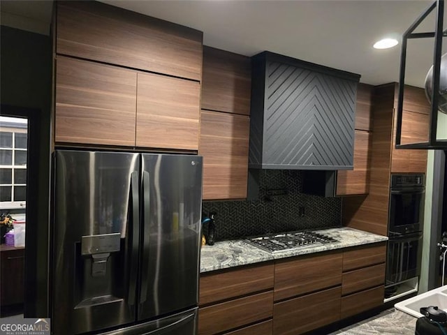 225 Nacoochee Dr, Woodstock, GA 30188 - kitchen featuring modern cabinets, stainless steel gas cooktop, refrigerator with ice dispenser, and dobule oven black