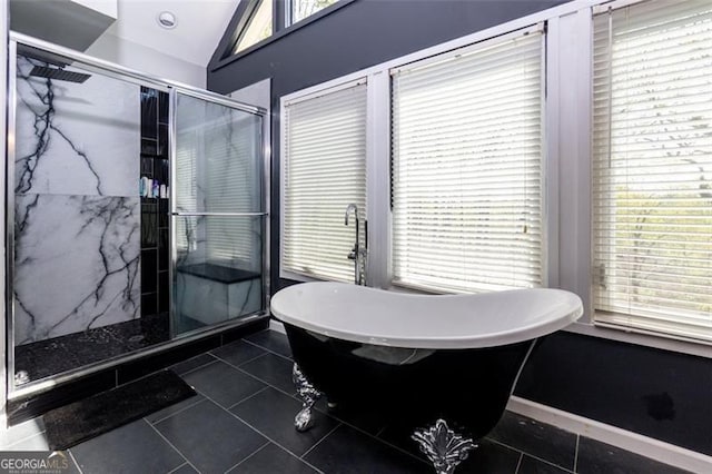 225 Nacoochee Dr, Woodstock, GA 30188 - bathroom featuring tile patterned floors, a marble finish shower, a freestanding bath, plenty of natural light, and vaulted ceiling