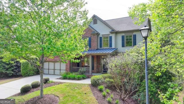 2725 Monet Dr, Cumming, GA 30041 - craftsman-style home featuring a porch, a standing seam roof, a garage, brick siding, and concrete driveway