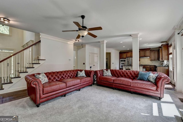 2725 Monet Dr, Cumming, GA 30041 - living room featuring carpet, a ceiling fan, baseboards, decorative columns, and stairway