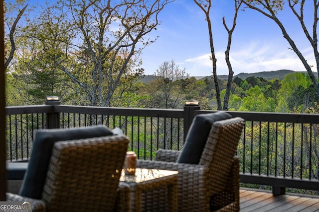wooden terrace featuring a forest view