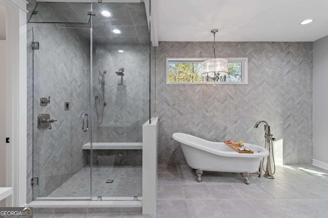 bathroom featuring recessed lighting, a freestanding tub, tile patterned floors, and a stall shower